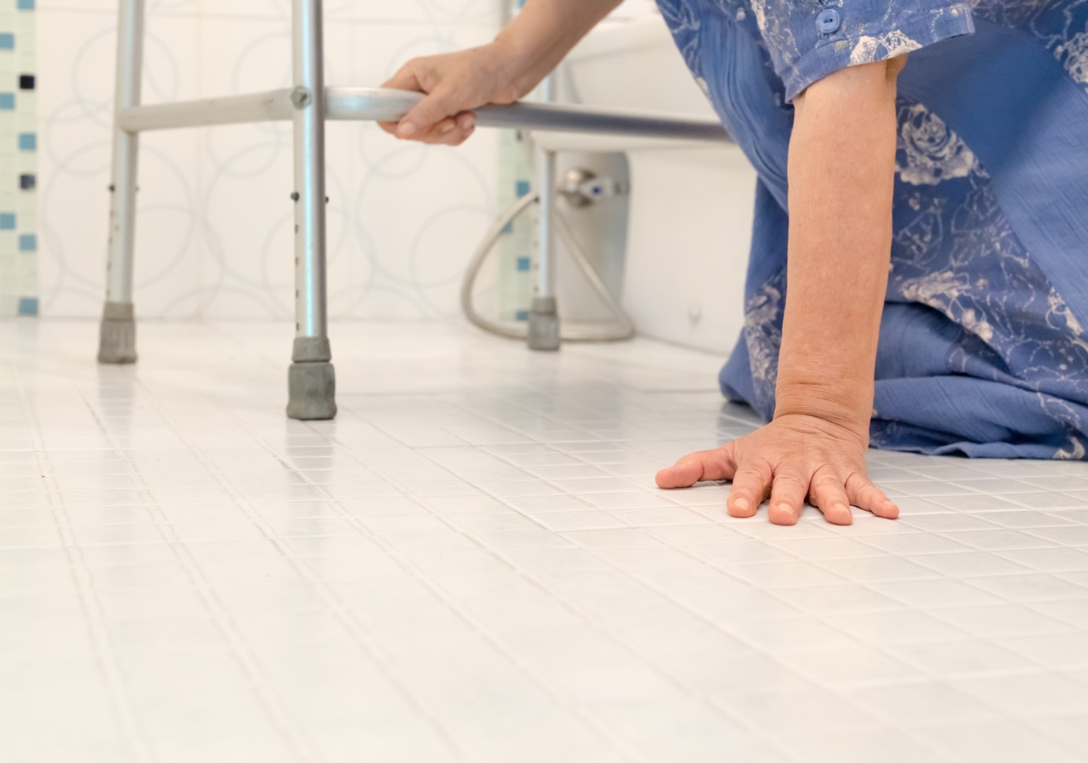 Elderly woman on bathroom floor after falling