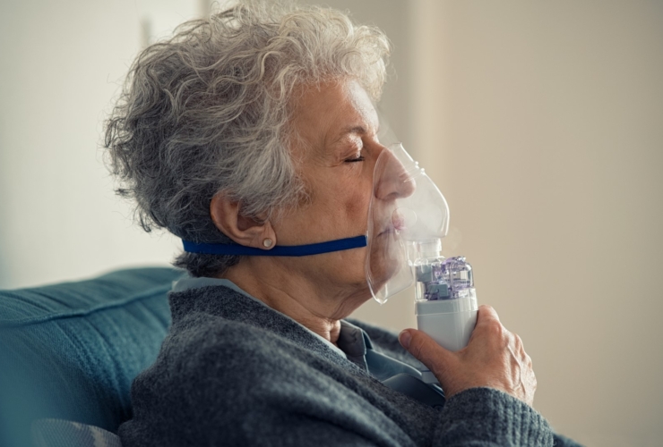 Elderly woman using nebulizer